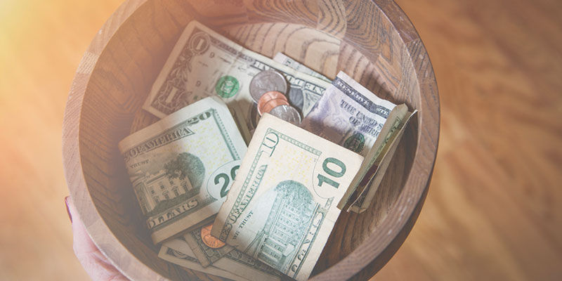 Money in a wooden bowl
